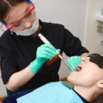 young-patient-black-goggles-getting-her-teeth-treated-by-female-hygienist-using-dental-curing-light_343059-402-150x150