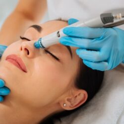delighted-nice-woman-lying-medical-bed-with-her-eyes-closed-while-having-hydrafacial_259150-9192