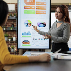 executive-manager-shwoing-marketing-graphs-freelancer-woman-analyzing-company-strategy-working-partnership-project-startup-office-marketing-team-brainstorming-business-ideas (1)
