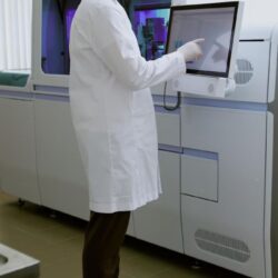 scientist-wearing-lab-coat-examining-data-touchscreen-device-medical-laboratory-setting-with_249974-27167