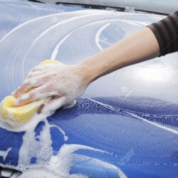 5279742-A-Hand-washing-a-blue-car-with-a-sponge-Stock-Photo-wash