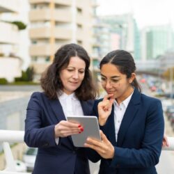 smiling-businesswomen-using-tablet-pc (1)