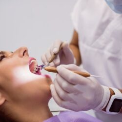 dentist-examining-female-patient-teeth
