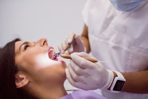 dentist-examining-female-patient-teeth dentist-examining-female-patient-teeth