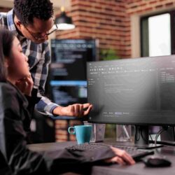 diverse-programmers-discussing-about-html-code-compiling-discovers-errors-standing-front-multiple-screens-startup-office-software-developers-working-server-interface-development11111