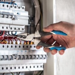 imgi_3_electrical-technician-working-switchboard-with-fuses-e1664028197764