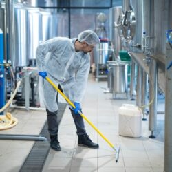 professional-industrial-cleaner-protective-uniform-cleaning-floor-food-processing-plant_342744-1209