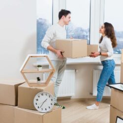 young-couple-looking-each-other-unpacking-moving-cardboard-boxes-home (1)