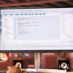 coder-workstation-programming-computer-writing-lines-code-close-up (1)