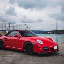 red-mini-coupe-parked-port-front-view-ship-seaside-1024x741